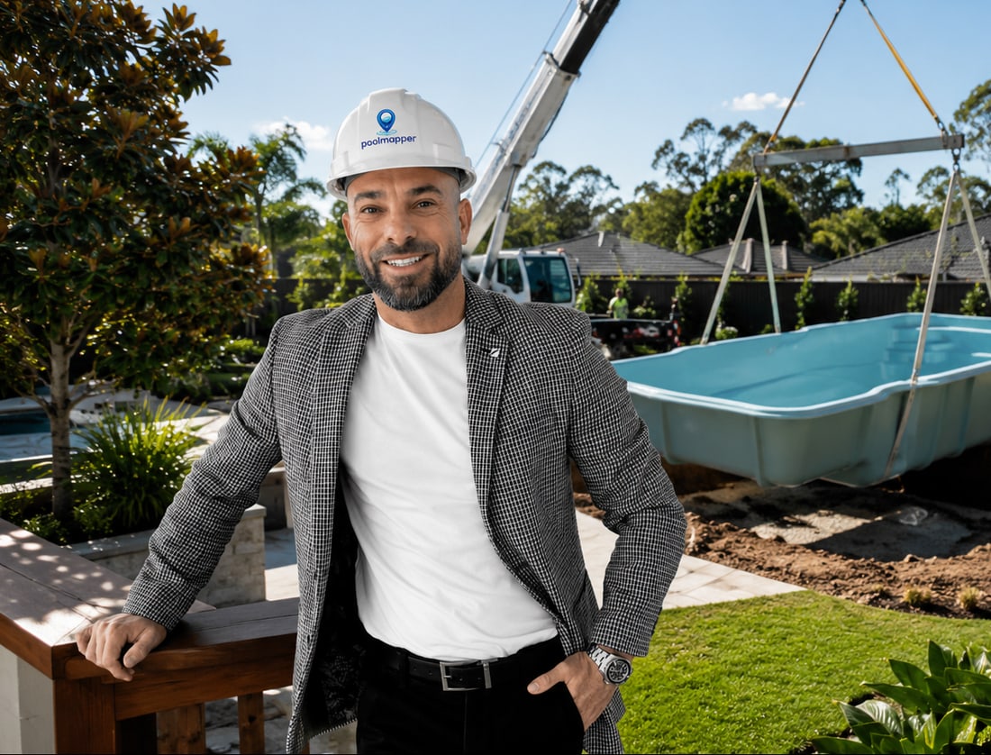 Paul Lommerse on site in a poolmapper hard hat as a pool is craned into a backyard